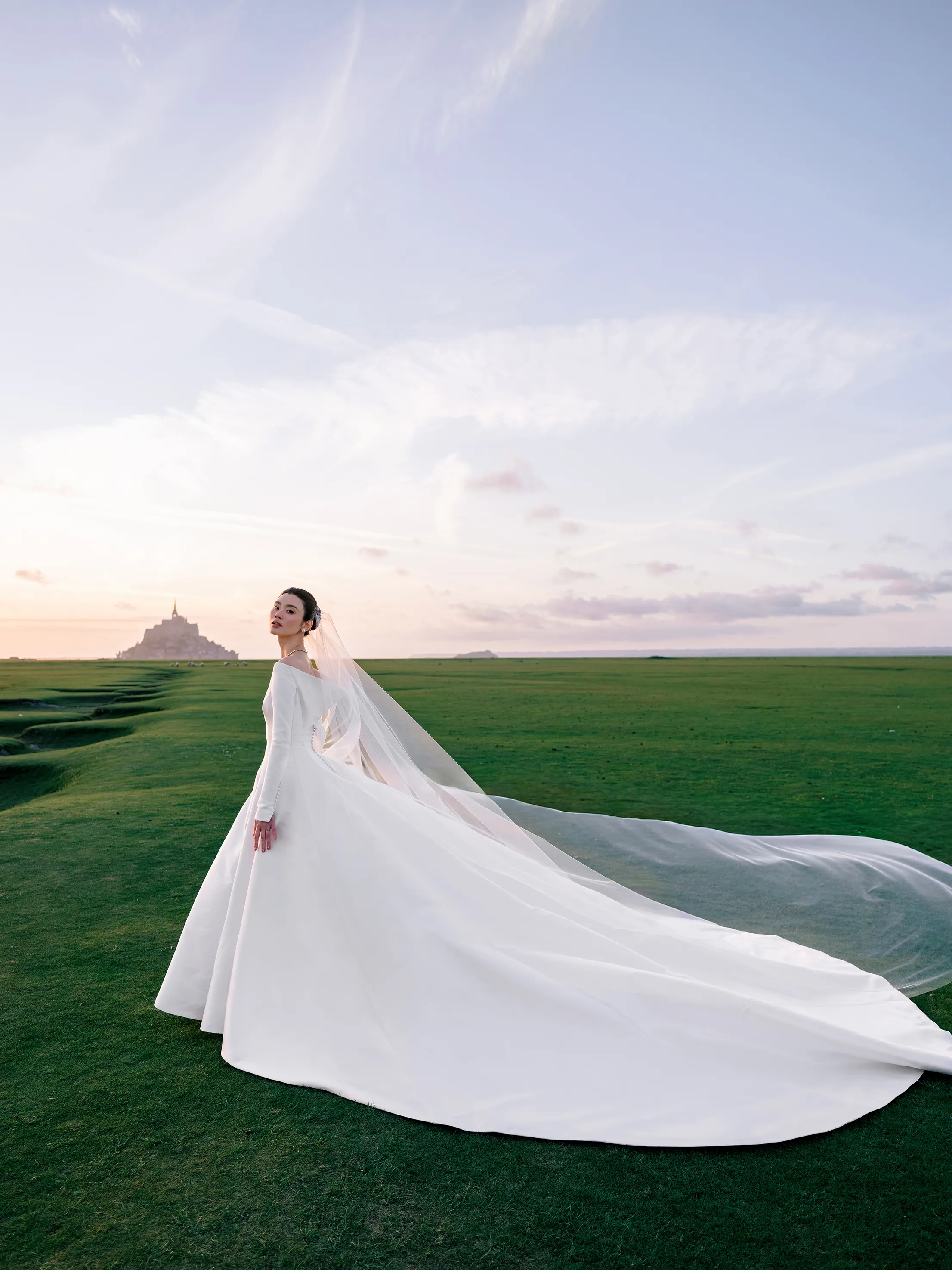 Model Ming Xi Wore Jonathan Anderson’s First-Ever Custom Dior Wedding Dress to Marry at Mont Saint-Michel